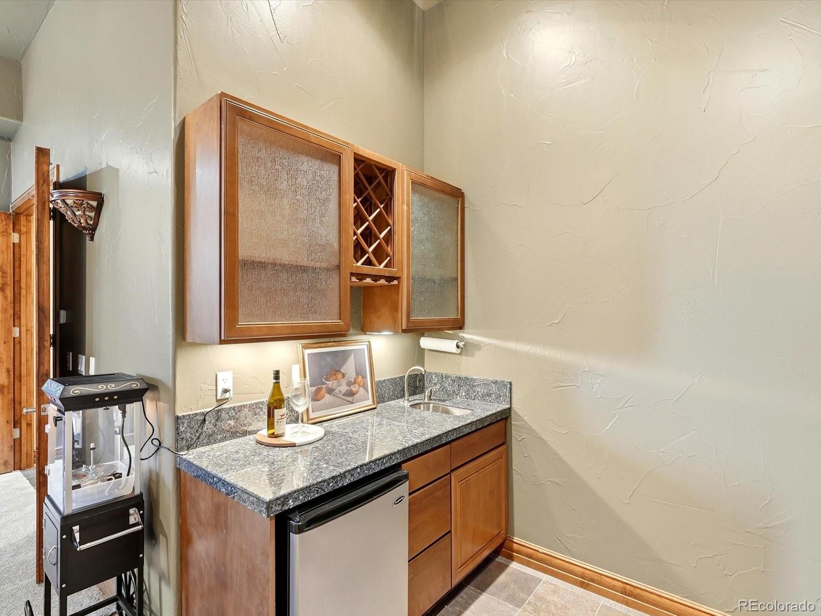 187 Fox Ridge Drive Evergreen, CO 80439 - Photo 42 of 49 a bathroom with a granite countertop sink and a mirror