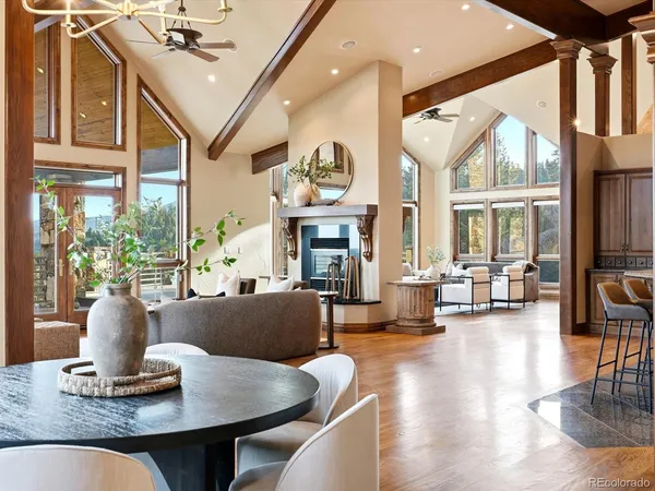 a living room with fireplace furniture and a large window