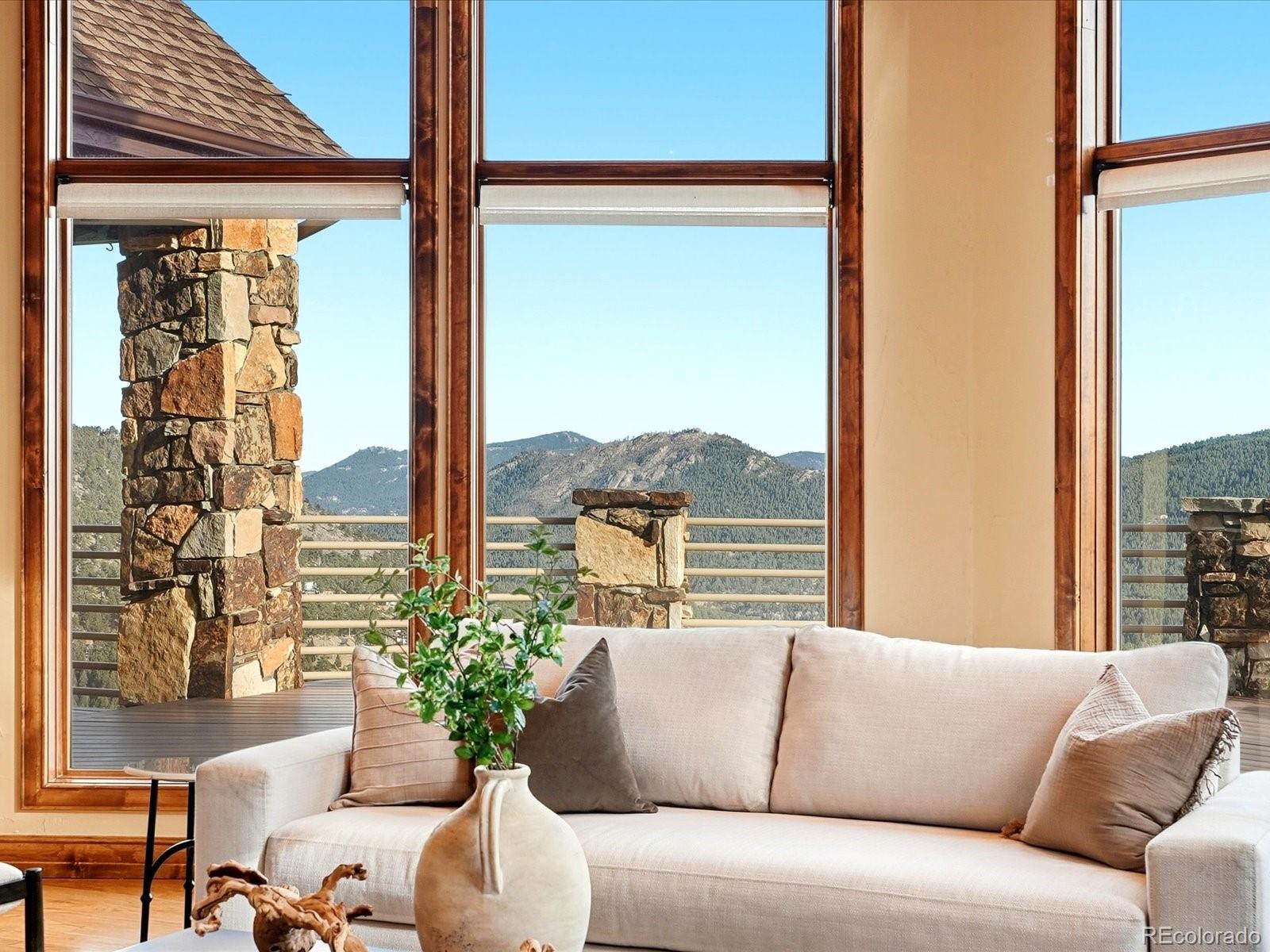 187 Fox Ridge Drive Evergreen, CO 80439 - Photo 6 of 50 a living room with furniture and a large window