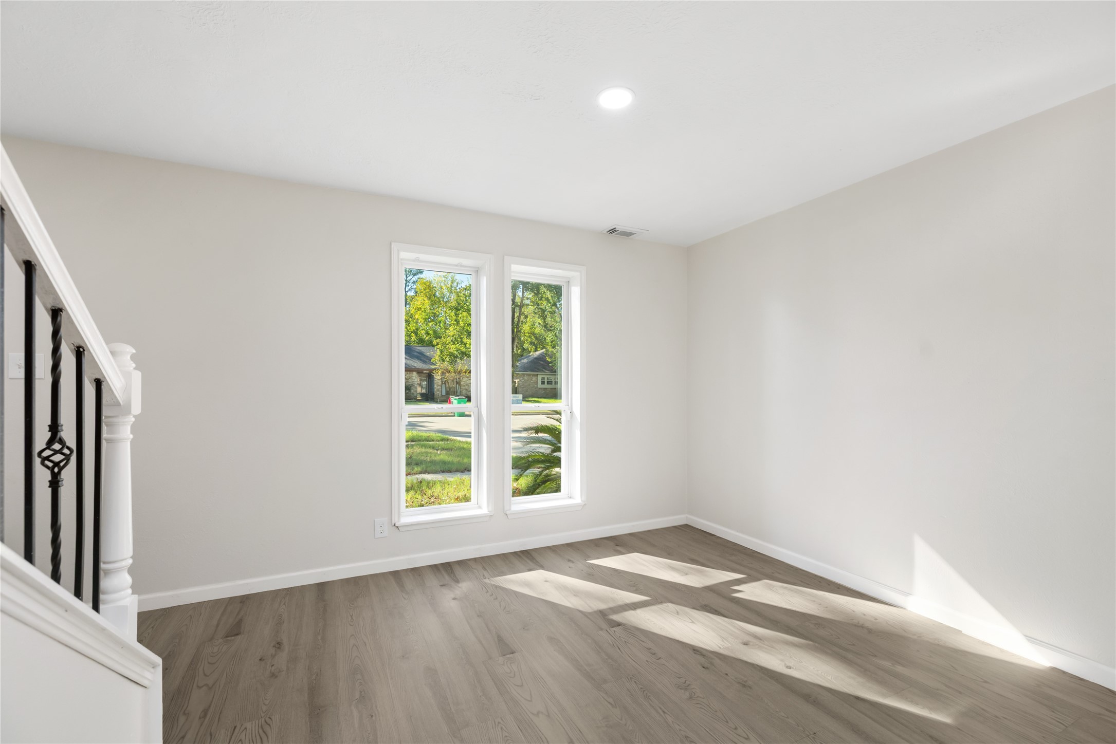 24118 Spring Mill Lane Spring, TX 77373 - Photo 5 of 24 an empty room with wooden floor and windows