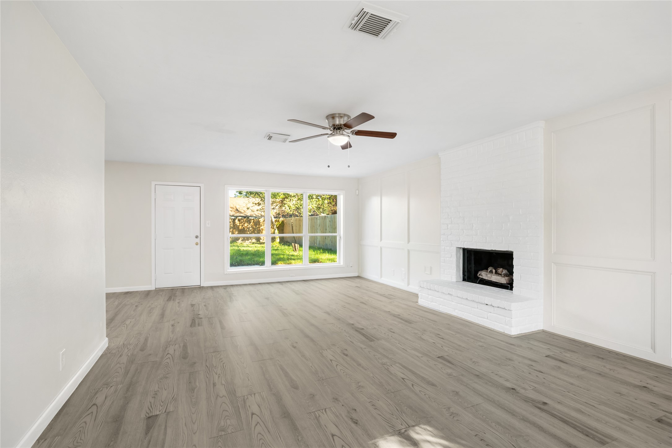 24118 Spring Mill Lane Spring, TX 77373 - Photo 8 of 24 wooden floor in an empty room with a window