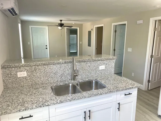 a bathroom with mirror sink and glass door
