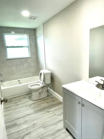 a bathroom with a sink toilet and vanity