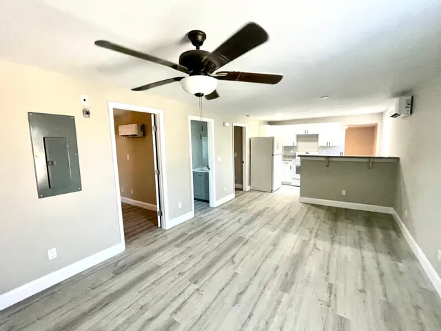 a view of a kitchen with a sink and wooden floor