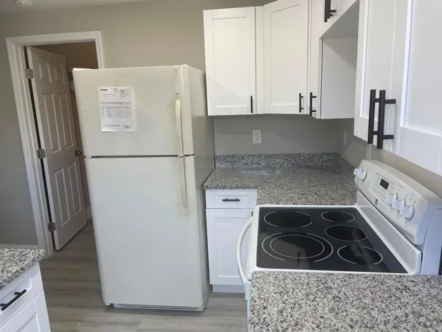 a white refrigerator freezer sitting inside of a kitchen