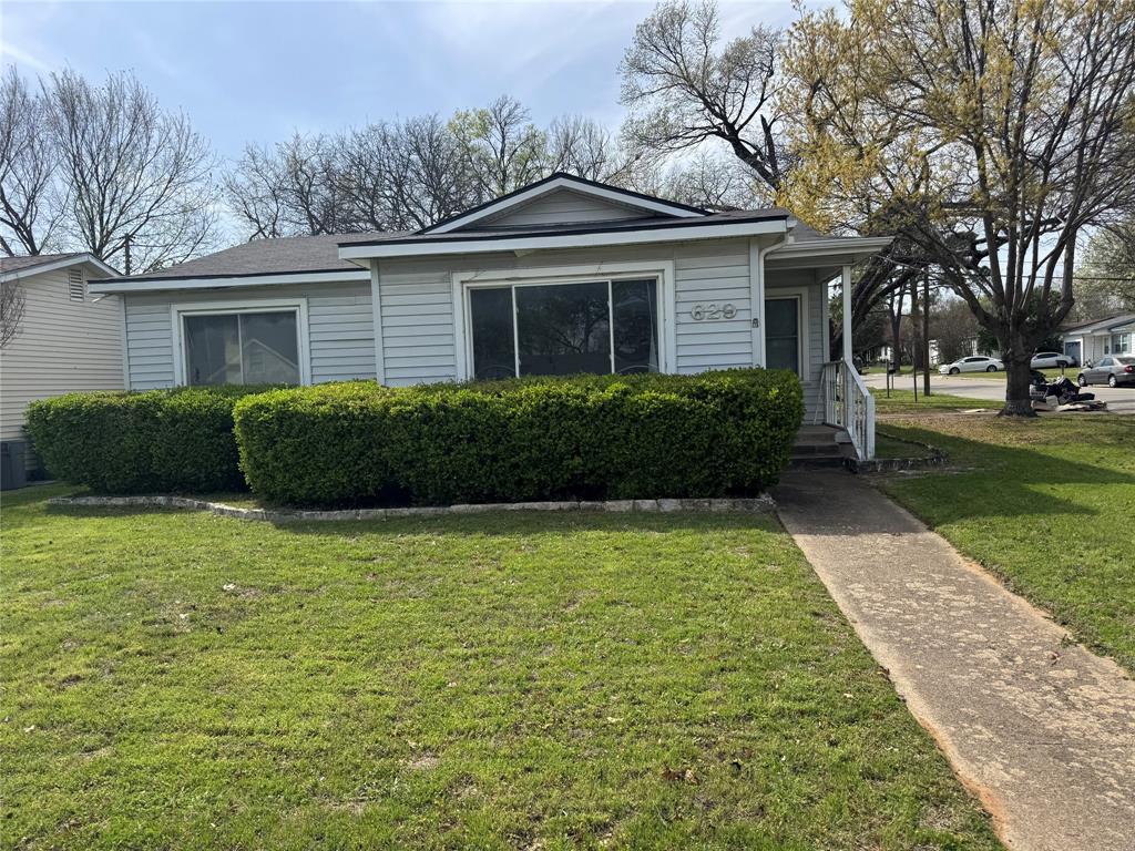629 Harrison Lane Hurst, TX 76053 - Photo 19 of 20 a front view of a house with garden