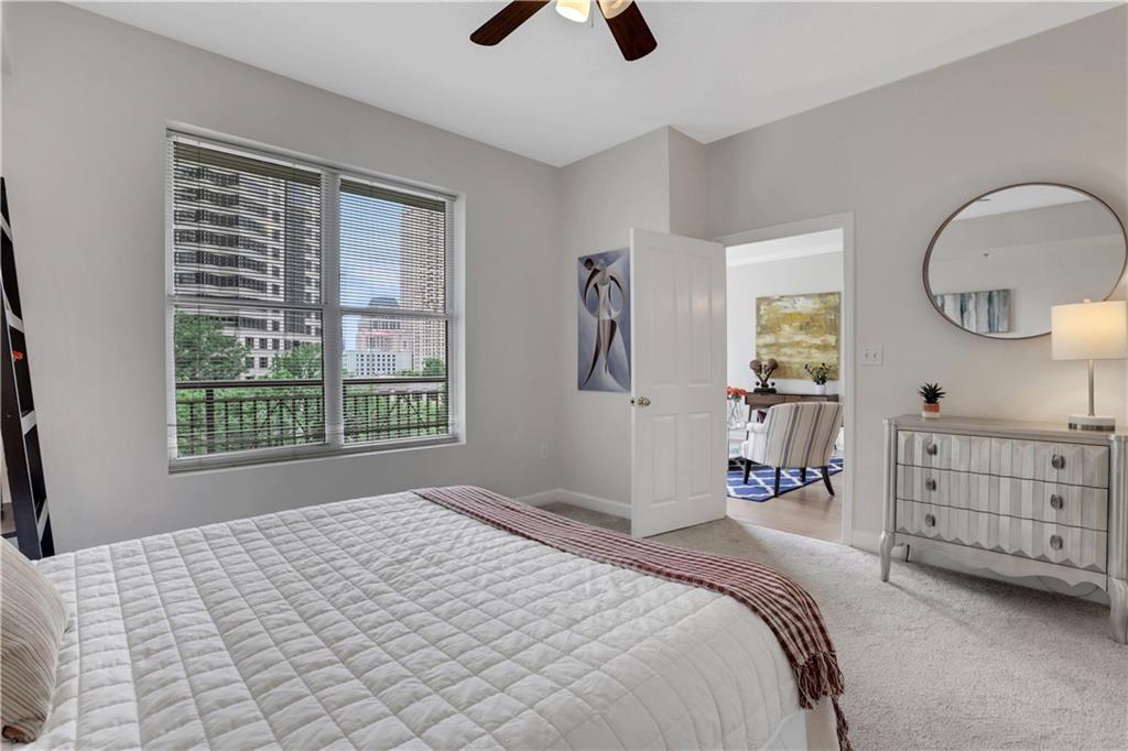 1101 Juniper Street Northeast, Unit 619 Atlanta, GA 30309 - Photo 16 of 28 a bedroom with a bed and a dresser