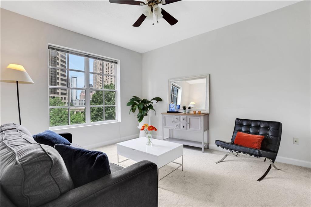 1101 Juniper Street Northeast, Unit 619 Atlanta, GA 30309 - Photo 19 of 28 a living room with furniture and a flat screen tv