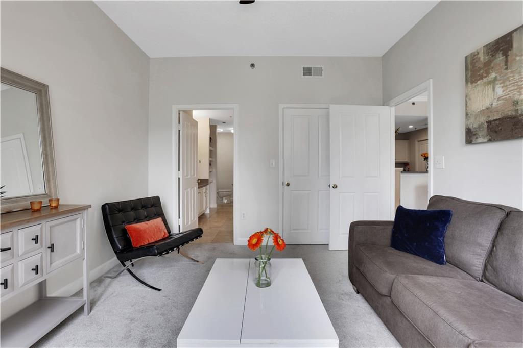 1101 Juniper Street Northeast, Unit 619 Atlanta, GA 30309 - Photo 21 of 28 a living room with furniture and white walls