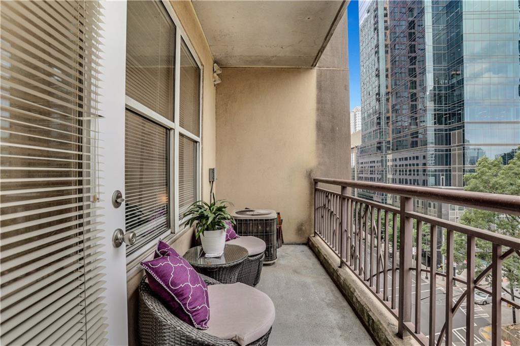 1101 Juniper Street Northeast, Unit 619 Atlanta, GA 30309 - Photo 25 of 28 a balcony with table and chairs