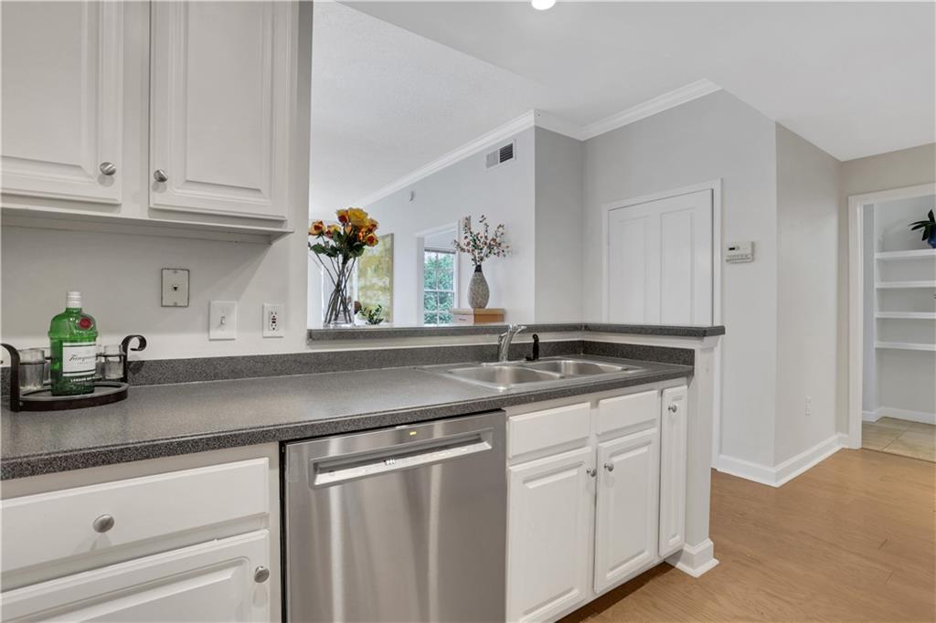 1101 Juniper Street Northeast, Unit 619 Atlanta, GA 30309 - Photo 5 of 28 a kitchen with granite countertop white cabinets and a sink