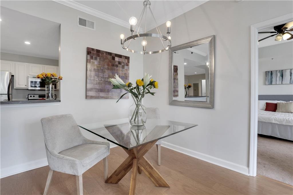 1101 Juniper Street Northeast, Unit 619 Atlanta, GA 30309 - Photo 7 of 28 a view of a dining room with furniture and wooden floor