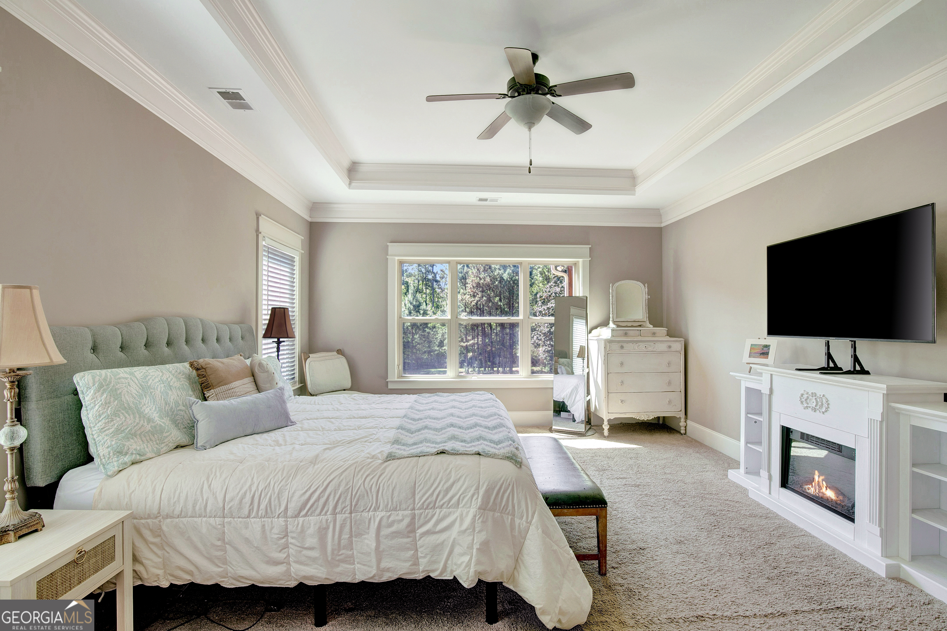 137 Kenmare Row Tyrone, GA 30290 - Photo 77 of 91 a spacious bedroom with a bed a flat screen tv and a couch