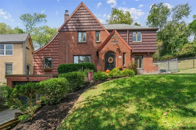 a front view of a house with a yard