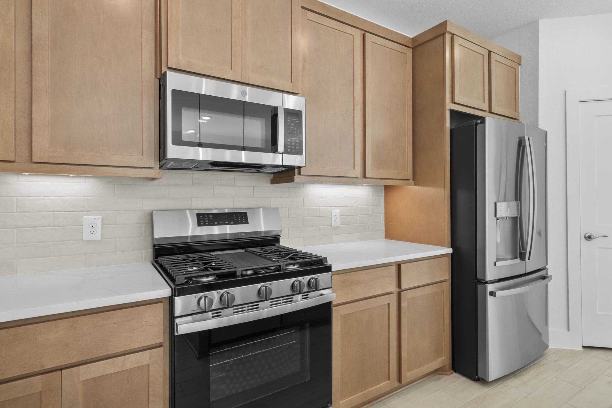 5227 Celestial Court Iowa Colony, TX 77583 - Photo 13 of 43 a kitchen with stainless steel appliances white cabinets and a stove top oven