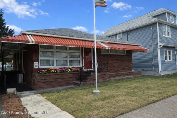 a front view of a house with a garden