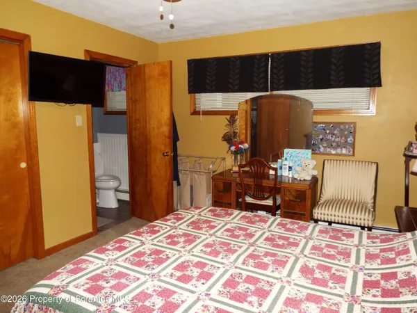 a bedroom with a bed and dresser