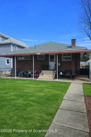 a view of a house with yard and front view of a house