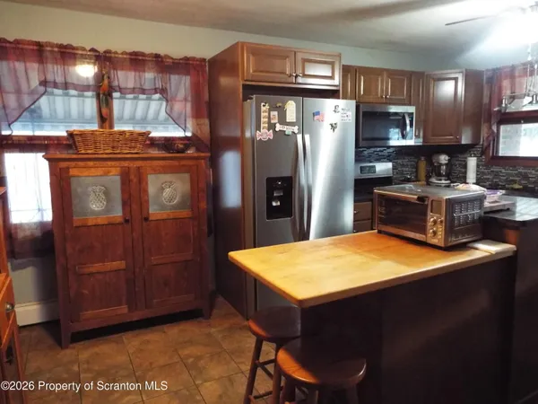 a kitchen with refrigerator and window
