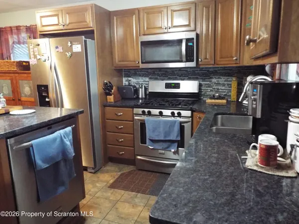a bedroom with a bed and teddy bear on bed