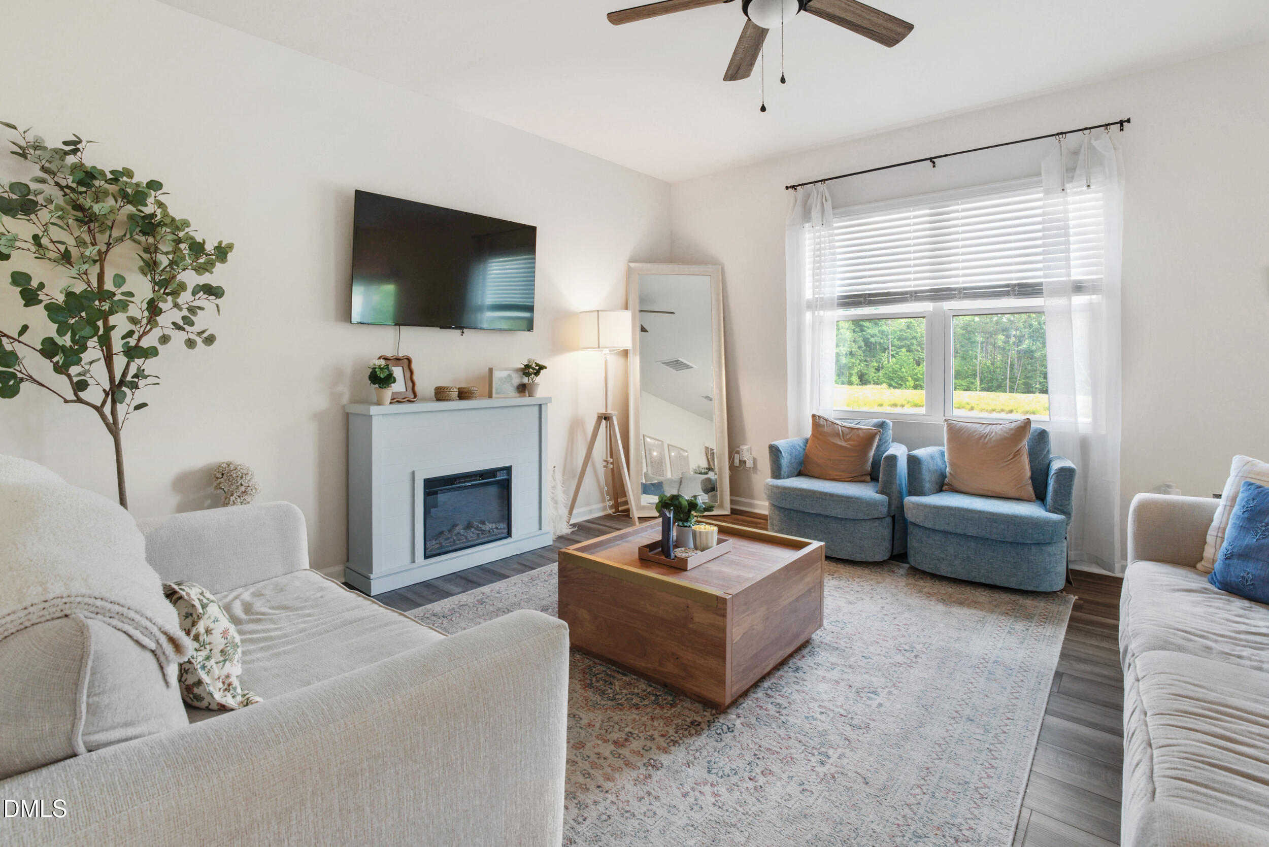 1416 Heron Pond Street Raleigh, NC 27604 - Photo 2 of 25 a living room with furniture a fireplace and a flat screen tv