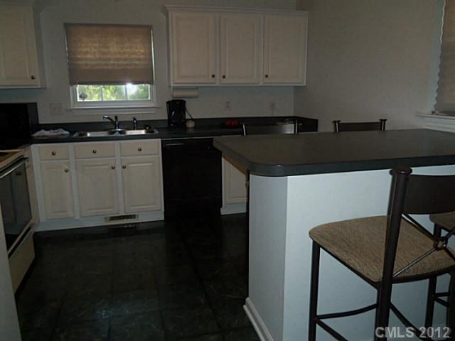 4841 Old Hickory Road, Unit 1 Lancaster, SC 29720 - Photo 3 of 11 a kitchen with a sink a stove and cabinets
