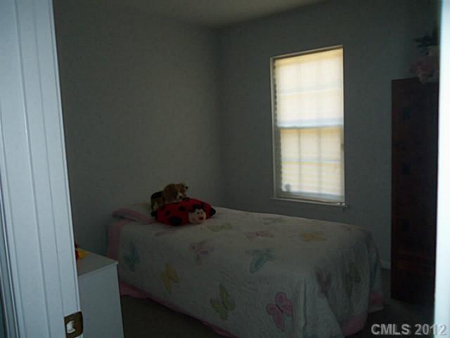 4841 Old Hickory Road, Unit 1 Lancaster, SC 29720 - Photo 5 of 11 a bed sitting in a bedroom next to a window
