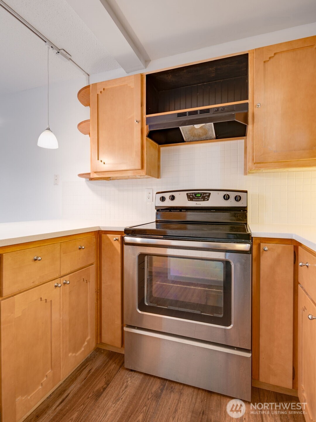 1425 South Puget Drive, Unit B3 Renton, WA 98055 - Photo 11 of 24 a kitchen with granite countertop cabinets stainless steel appliances and wooden floor
