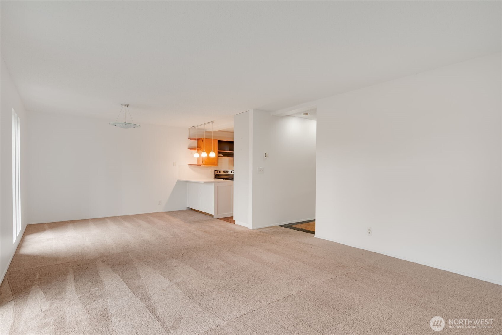 1425 South Puget Drive, Unit B3 Renton, WA 98055 - Photo 8 of 24 a view of a kitchen with a sink and a refrigerator