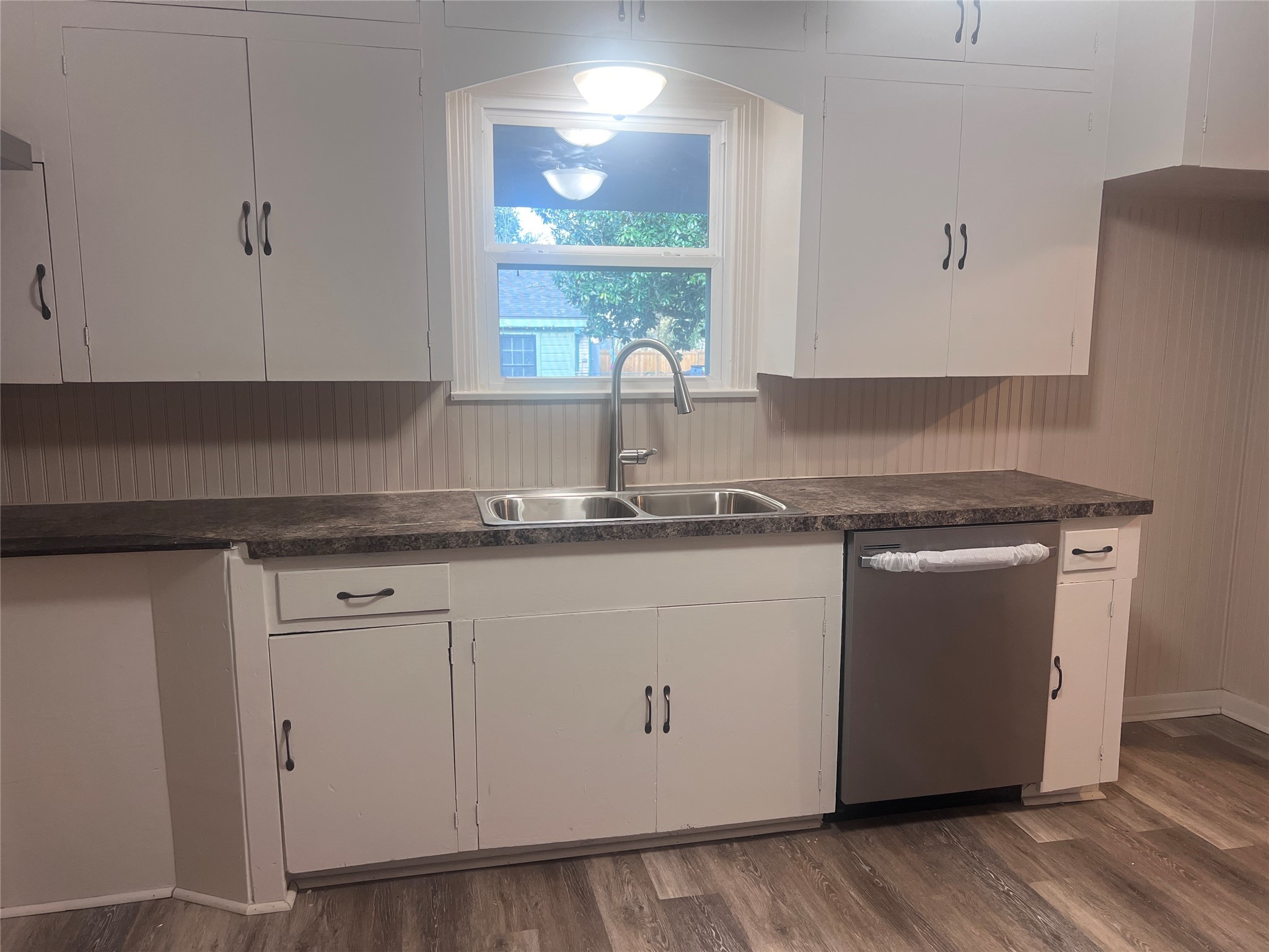 620 Koehl Street Wharton, TX 77488 - Photo 11 of 37 a kitchen with granite countertop white cabinets and white appliances