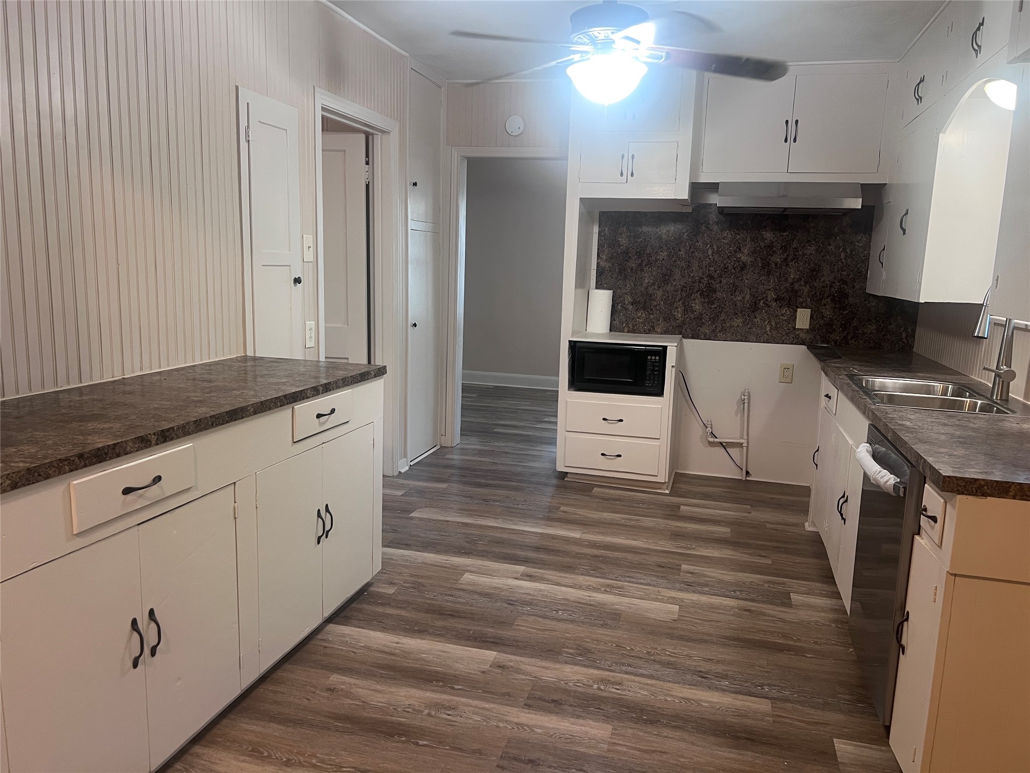 620 Koehl Street Wharton, TX 77488 - Photo 14 of 37 a kitchen with stainless steel appliances granite countertop a stove a sink and white cabinets