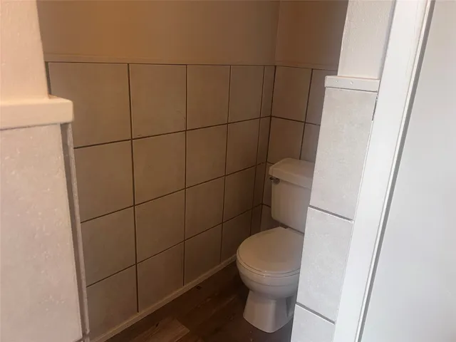 an empty room with a ceiling fan and a window