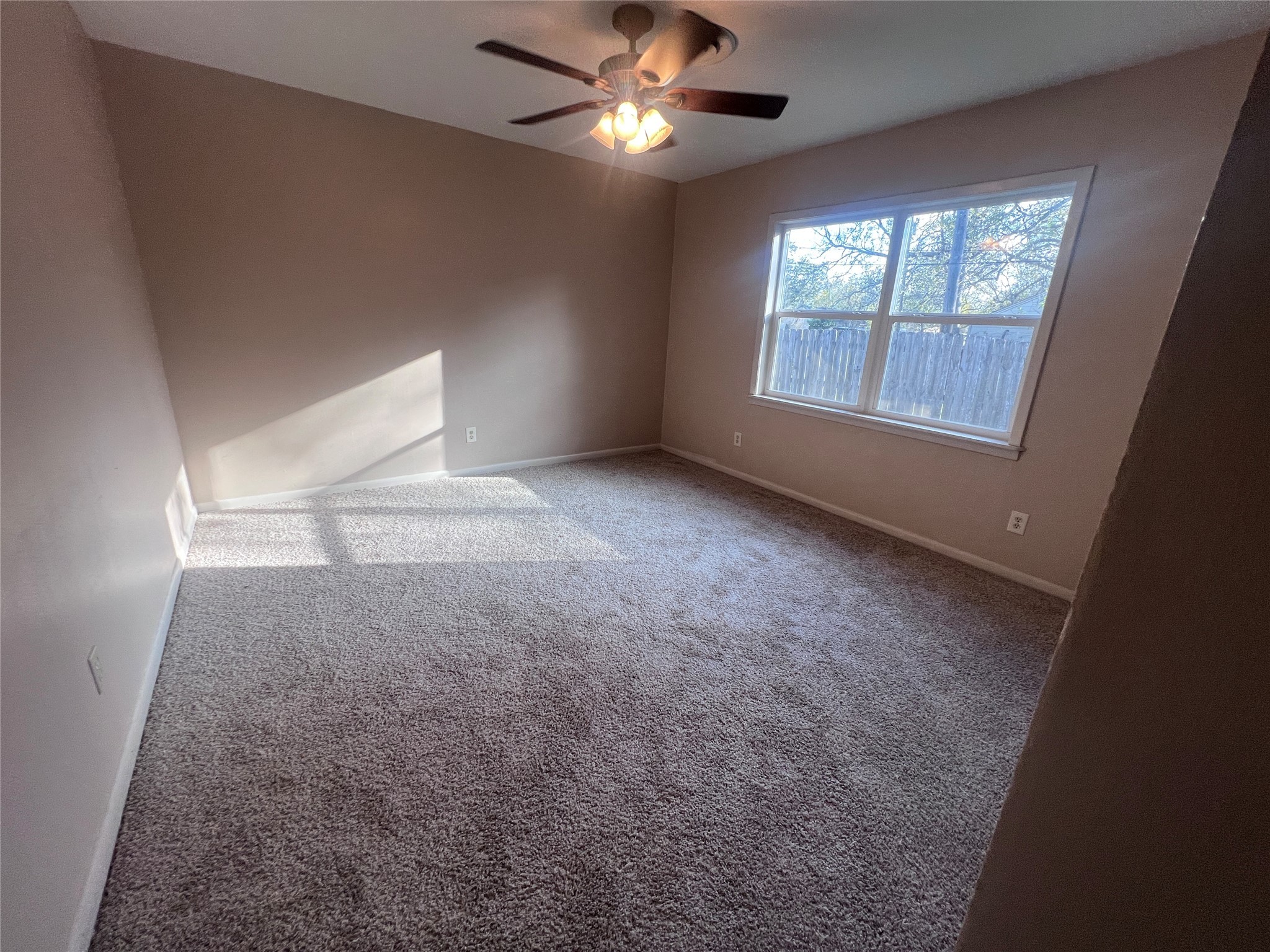 620 Koehl Street Wharton, TX 77488 - Photo 21 of 37 en empty room with windows and fan