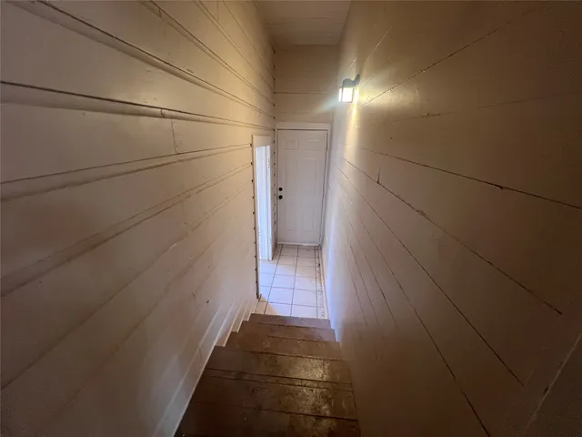 en empty room with windows and fan