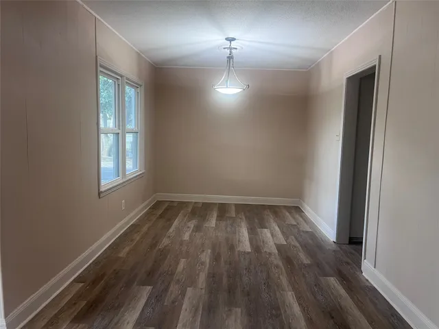 a kitchen with granite countertop white cabinets white appliances a sink and a window