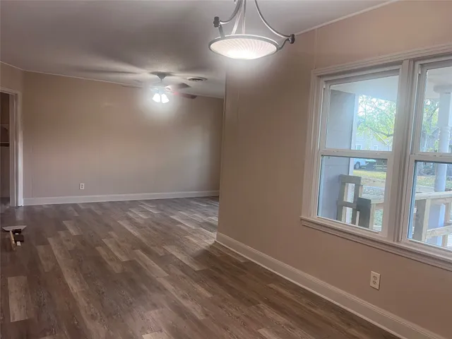 a kitchen with granite countertop white cabinets and window