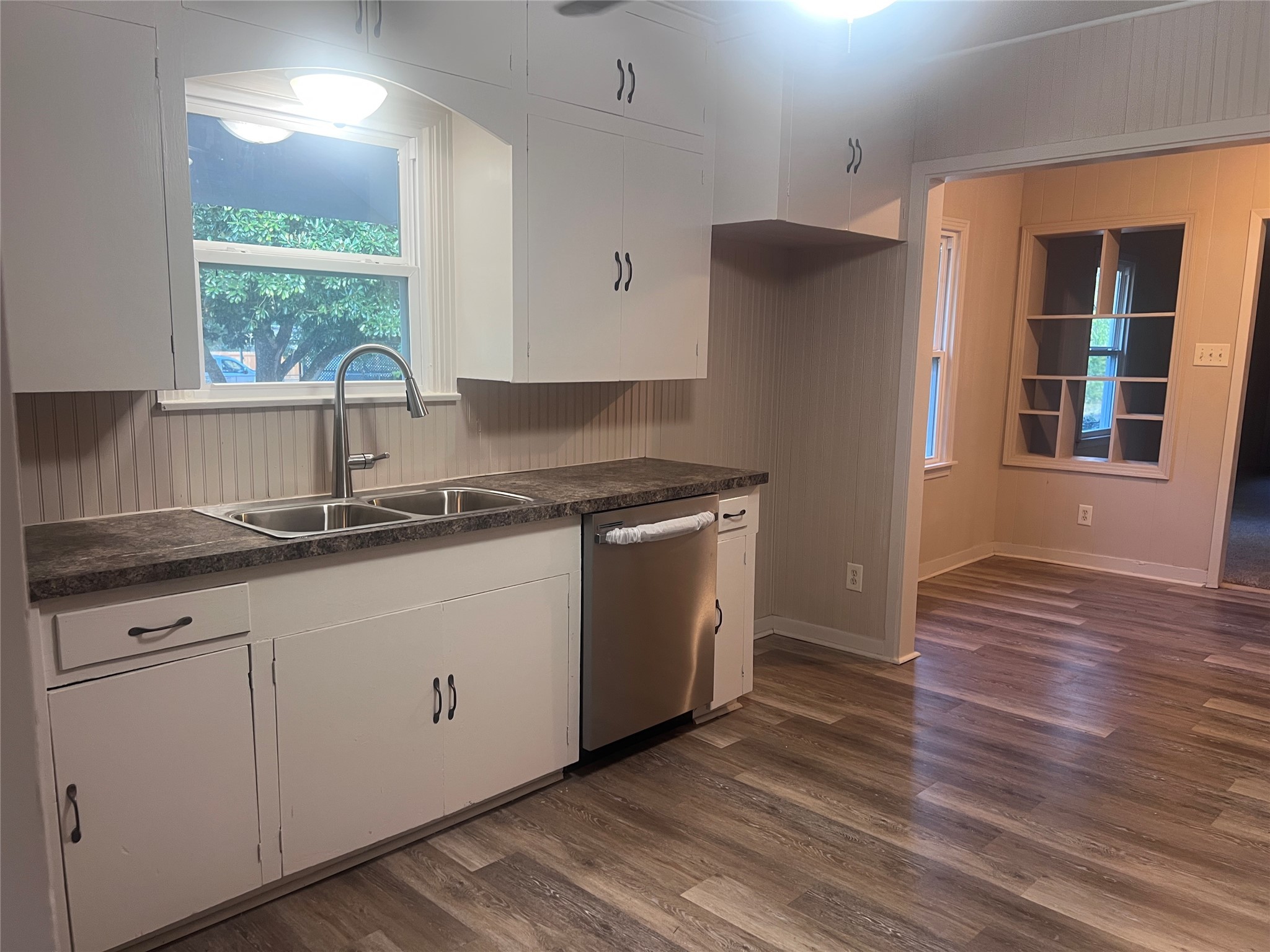 620 Koehl Street Wharton, TX 77488 - Photo 9 of 37 a kitchen with granite countertop white cabinets white appliances a sink and a window
