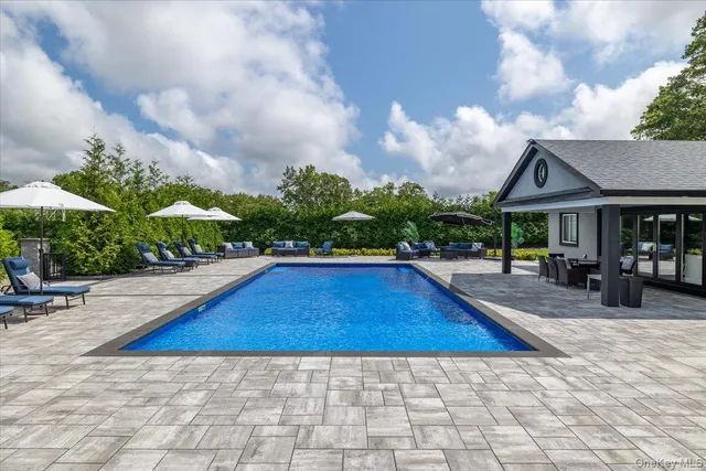 a view of swimming pool with sitting area and furniture