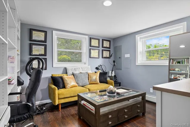 a living room with furniture a window and a wooden floor
