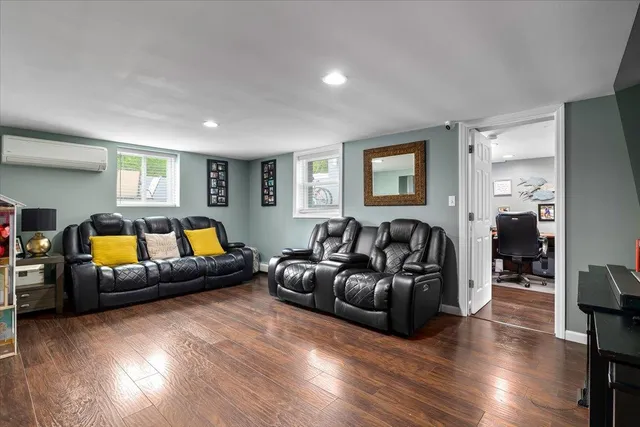 a living room with furniture window and wooden floor
