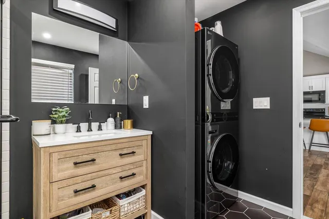 a utility room with closet and mirror