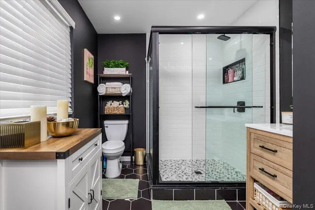 a utility room with closet and mirror