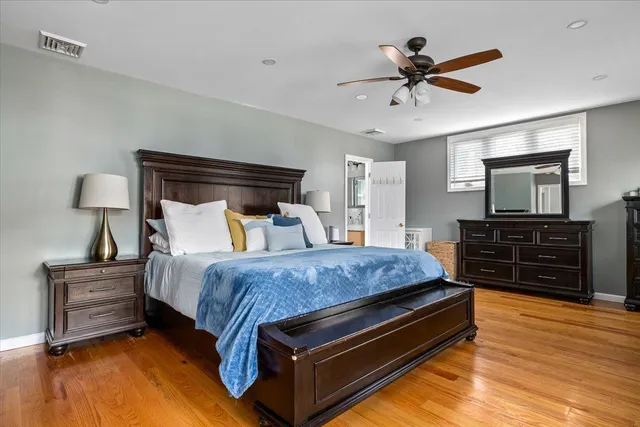 a bed room with a bed window and dresser