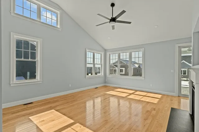 a view of large kitchen with cabinets and wooden floor