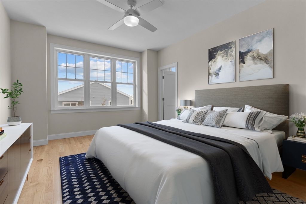 47 Spring Street Rehoboth, MA 02769 - Photo 19 of 35 a bedroom with a large bed and a window with wooden floor