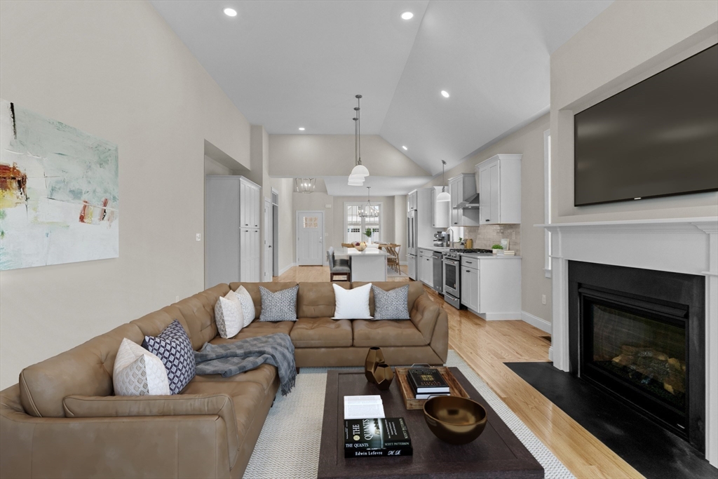 47 Spring Street Rehoboth, MA 02769 - Photo 23 of 35 a living room with furniture a flat screen tv and a fireplace