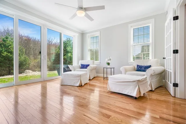 a view of a house with a yard and potted plants