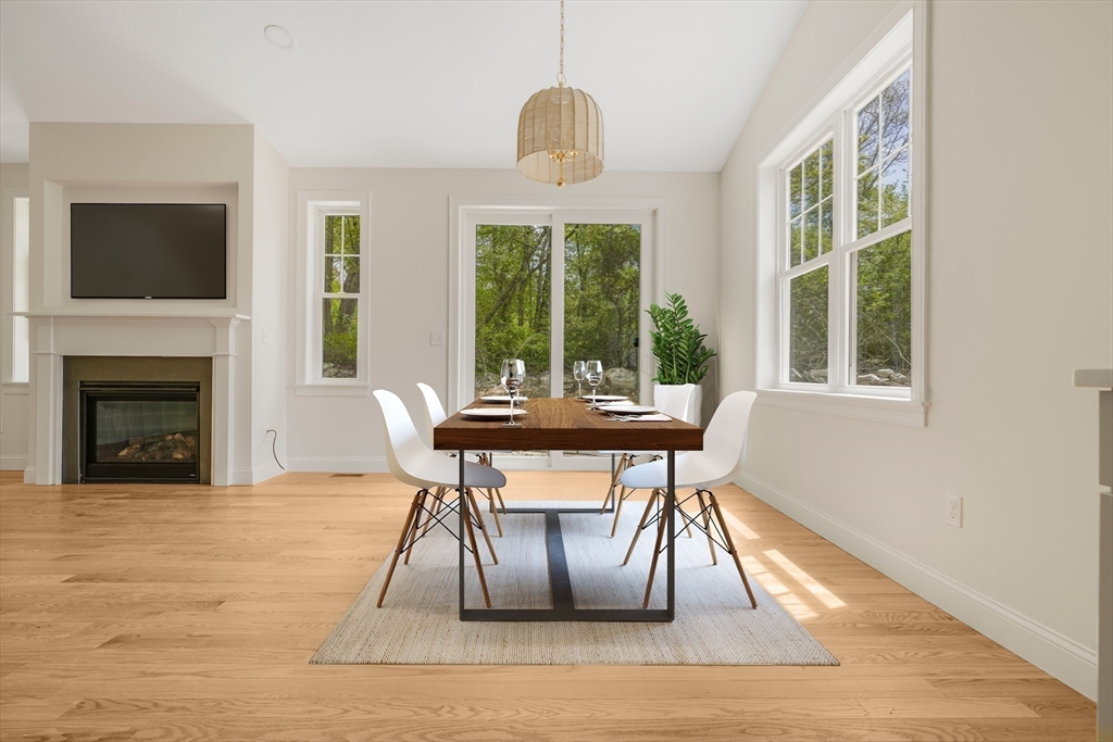 47 Spring Street Rehoboth, MA 02769 - Photo 9 of 35 a dining room with furniture a fireplace and wooden floor