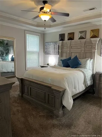 a bedroom with a bed and a chandelier