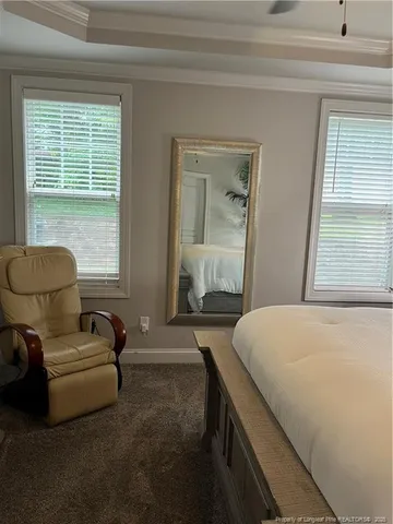 a bedroom with a bed and a couch next to a window